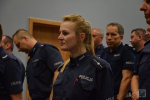 policjanci ruchu drogowego w auli przed ogłoszeniem wyników, w środku kadru jest policjantka